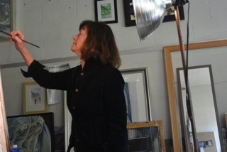 Joan Bevelaqua Holding a Paint Brush